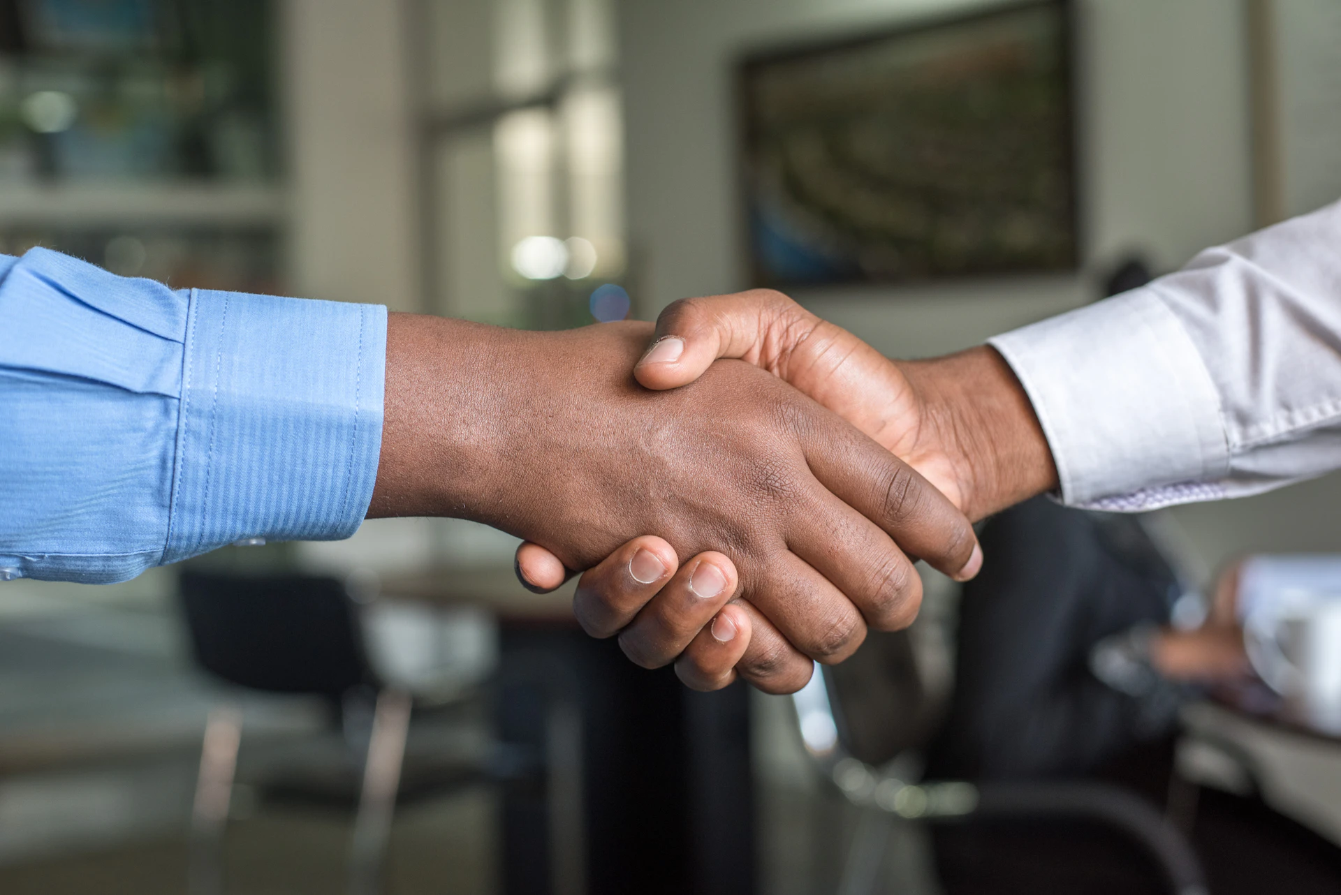 Professional business handshake in modern office - partnership and trust